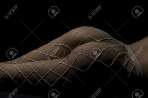 95682607-silhouette-of-a-body-part-nude-woman-with-fishnets-on-black-background.jpg
